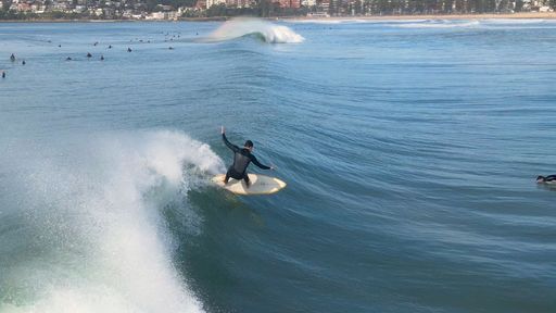 A high angle shot of a surfer on the water near Manly Beach, Sydney, Australia