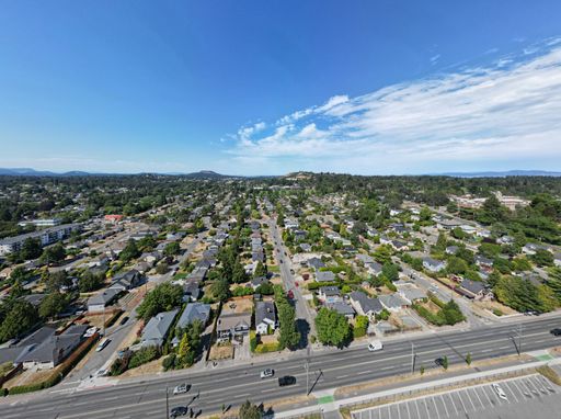 An aerial shot of a suburban area filled with trees and houses