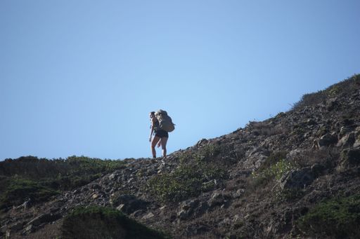 Picture of a woman climbing and looking back