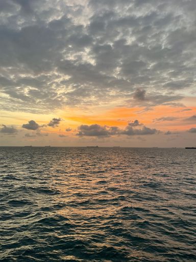 A vertical shot of the fascinating sunset at the Gulf of Guinea