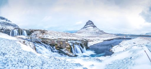 A view of the Kirkjufell mountain and Kirkjufellsfoss waterfall in winter. Iceland.