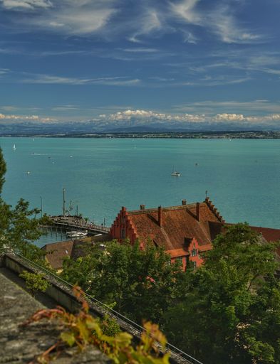 The view of a building and pier before the seascape under the blue sky