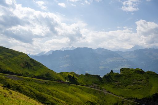 The cloudy sky over green hills on a sunny day in summer