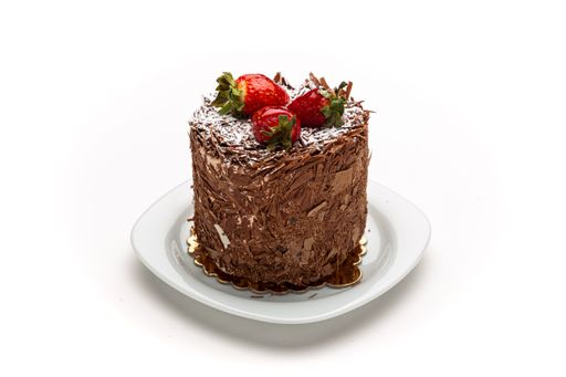 A small delicious chocolate cake with strawberries on white plate isolated on white background