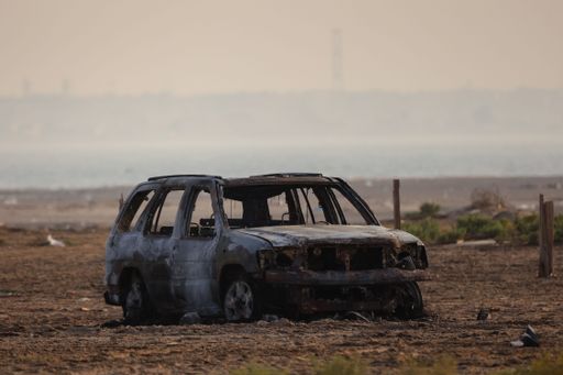 A beautiful shot of an abandoned rusty car in a field