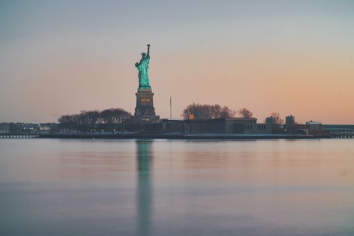 A view of a statue of Liberty and its reflection in the water in Jersey City, The USA