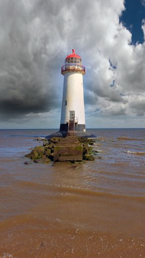 A vertical shot of a mesmerizing view of Point of Ayr Lighthouse in Holywell, UK
