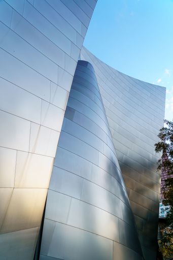 A vertical shot of reflective walls of Walt Disney Concert Hall in Los Angeles, CA, USA