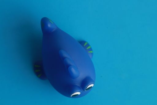 A closeup shot of a toy bathtub in a blue fish shape for children