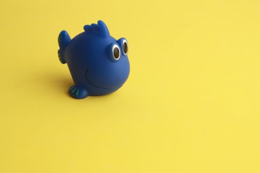 A closeup shot of a toy bathtub in a blue fish shape for children