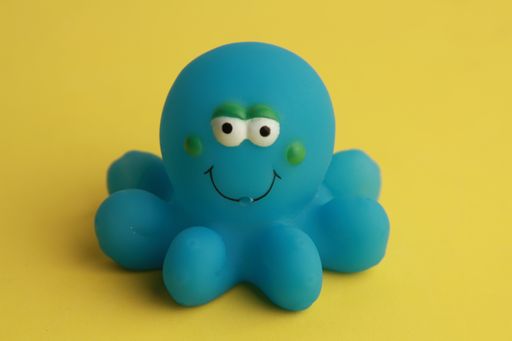 A close up shot of a blue toy octopus for a bathtub