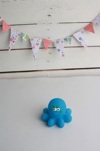 A high angle shot of a child toy of a blue octopus bathtub