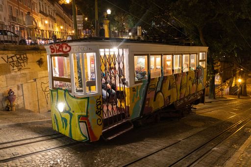 A typical vintage electrical tram funicular running at night in Lisbon, Portugal