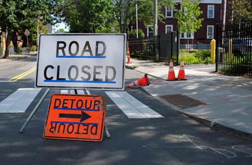 The road closure sign during road work on a sunny day in Boston