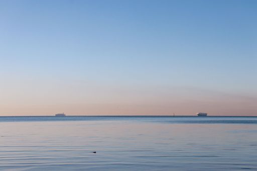 A beautiful shot of calm water under a blue sunset sky