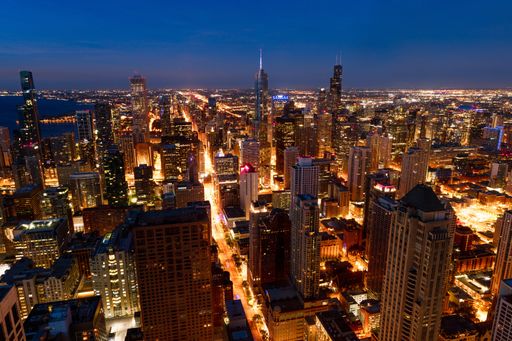 A cityscape of Chicago surrounded by buildings and lights in the evening in the US