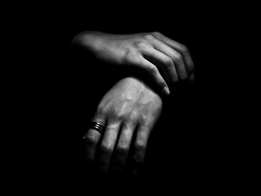A grayscale closeup shot of a pair of elegant hands