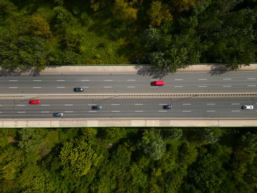 An aerial view of fast moving cars on the road