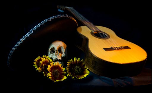 human skull, mexican hat, guitar and sunflowers for day of the dead