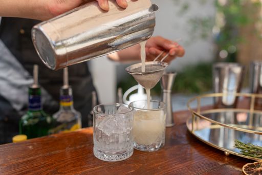 The bartender hands preparing a cocktail