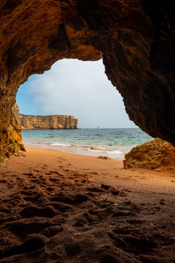 A natural cave in the Algarve on the beach at Praia da Coelha, Albufeira, Portugal