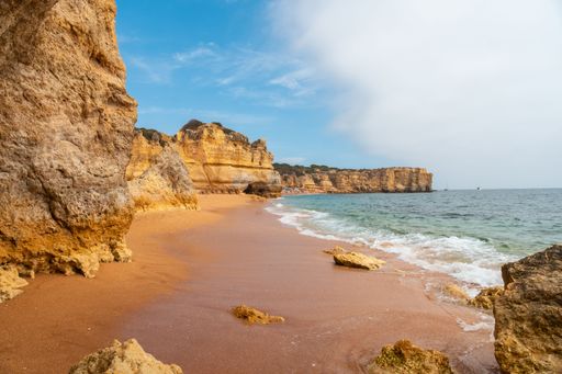 A scenic view of the beach at Praia da Coelha, Albufeira, Portugal, summer vacation