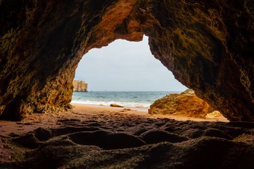 A natural cave in the Algarve on the beach at Praia da Coelha, Albufeira, Portugal