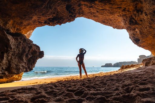 An attractive Caucasian female in the natural cave in the Algarve at Praia da Coelha, Albufeira