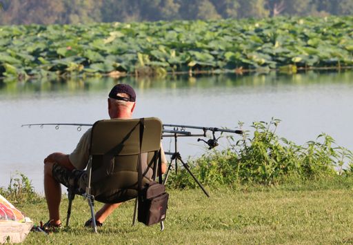 A back view of a fisherman on the lake of Mantua
