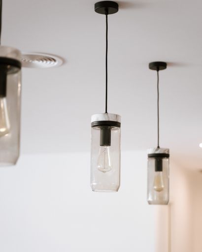 The beautiful and contemporary glass chandeliers  hanging from the ceiling