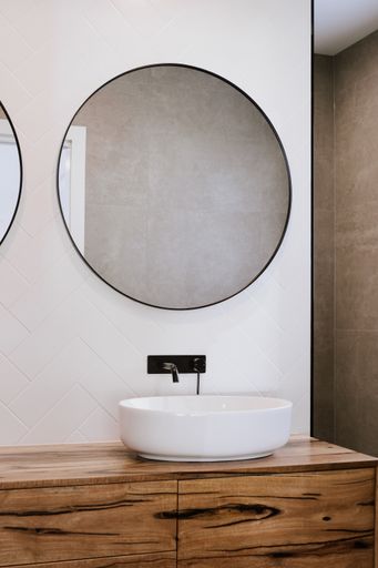 The beautiful modern style black faucet with ceramic sink in the bathroom