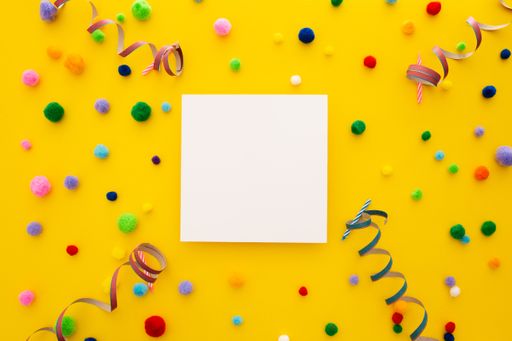 A top view of a blank square paper surrounded by confetti on a yellow background