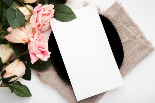A blank piece of paper surrounded by roses