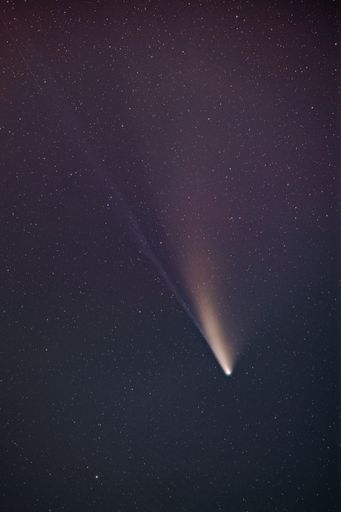 Spectacular view of the comet Neowise on a dark purple night sky