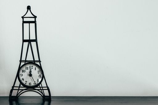 A metal small Eiffel tower vintage decoration clock with a copy space