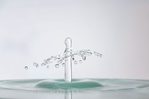 A closeup of a splash of water drops with a white background