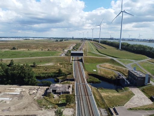 A railway near wind turbines on a sunny day