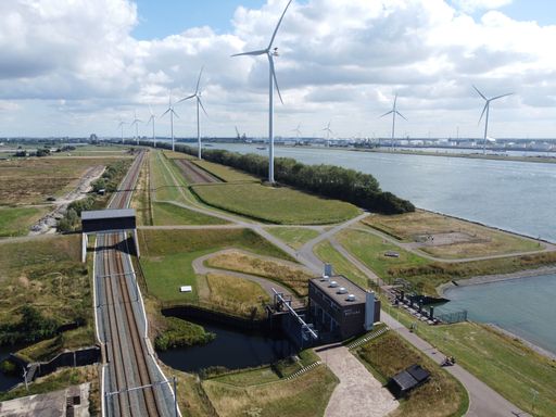 A railway near wind turbines on a sunny day