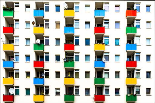 A modern building with colorful balconies making the scenery a happy scene from a movie