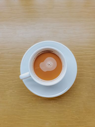 Top view of coffee latte with foam on top. Looks like milk tea too.