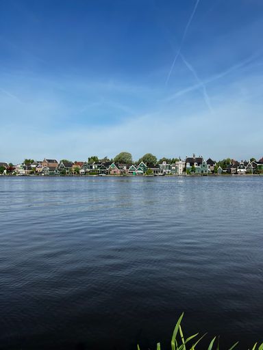 The vertical view of waterside buildings under the blue sky in Netherlands