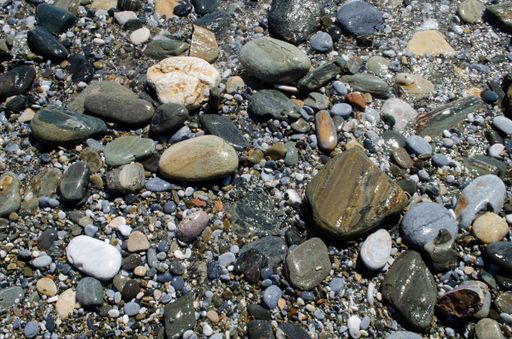 A closeup shot of a group of small and rounded stones at the beach