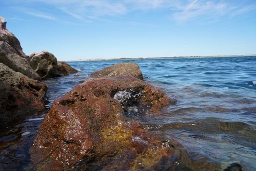 Big stones on the lakeshore during the daytime