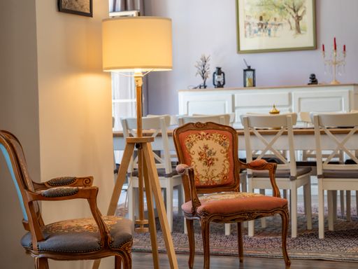 A beautiful shot of a vintage style interior of a dining room with antique chairs