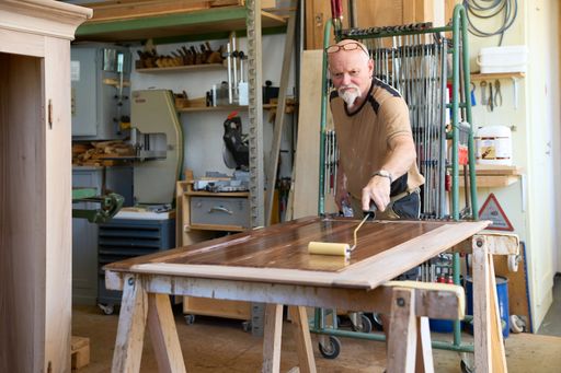 A beautiful shot of a Caucasian carpenter working in his workshop
