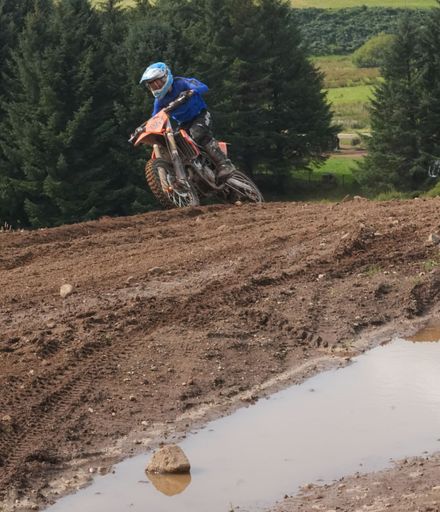 A moto x rider taking the corner at the track