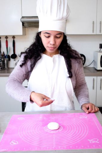 The female chef makes a cake and fondant