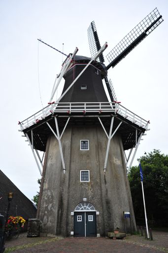 A vertical shot of an old windmill in Amsterdam
