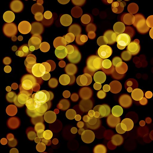 Bokeh lights in yellow colors on a black background