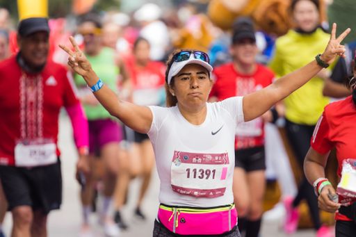 A woman running the International Marathon of Mexico city on the street